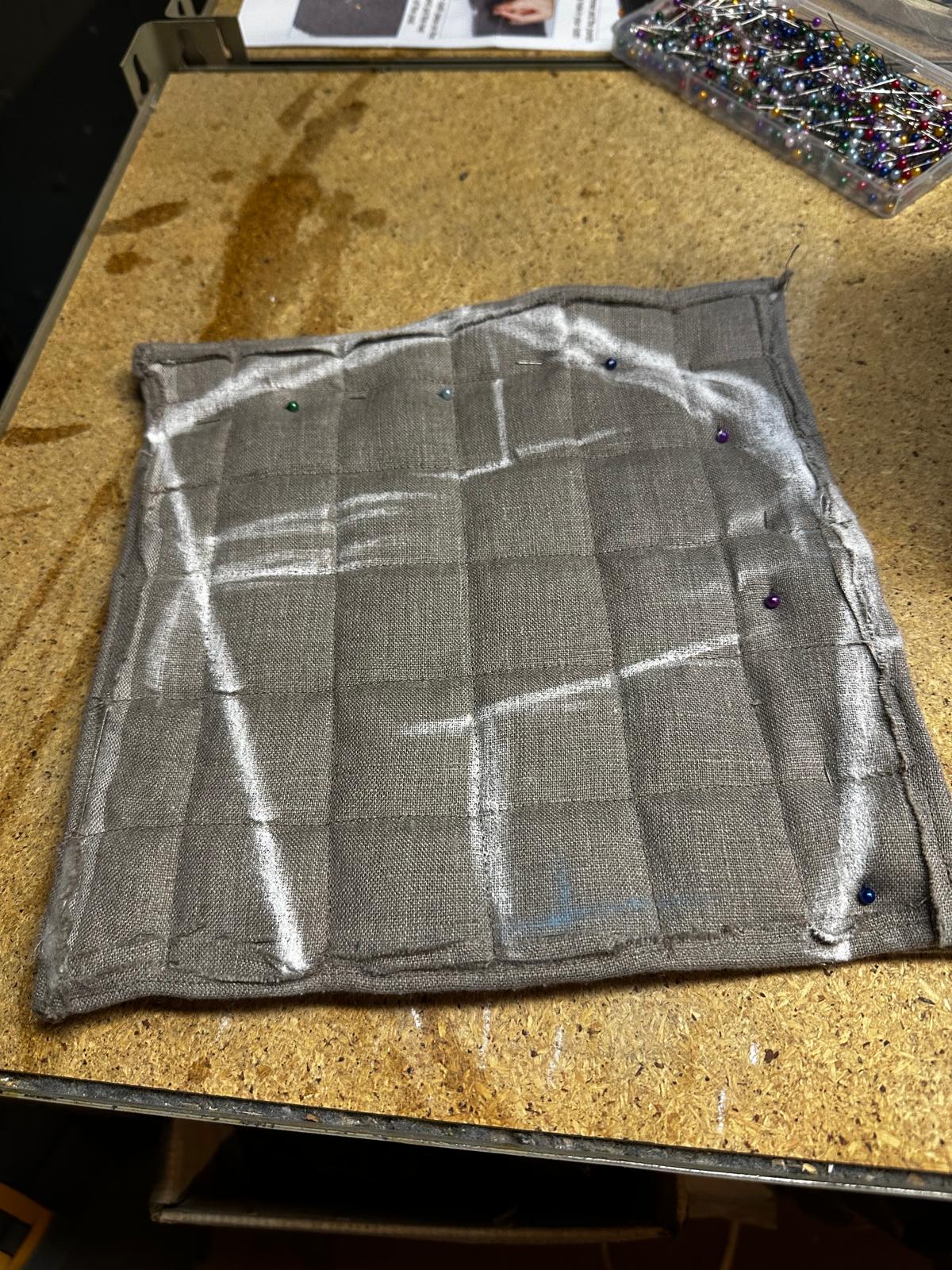 An unfinished handmade padded coif made of natural linen and wool batting